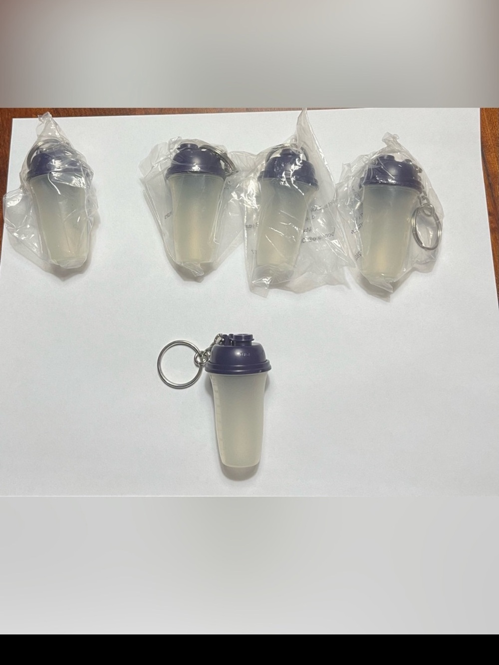 5 Tupperware Mini Shaker Bottle Keychains. Approximately 2 1/2 inches tall.